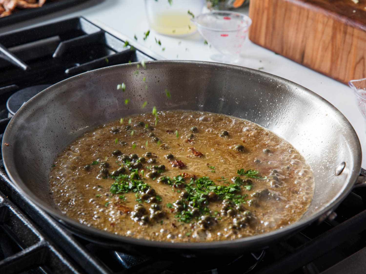 Melted butter, lemon juice, and herbs simmering in a pan.