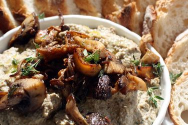 Closeup of awesome mushroom pâté, served with sliced baguette.