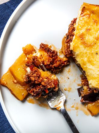 Overhead view of a fork of moussaka on a plate
