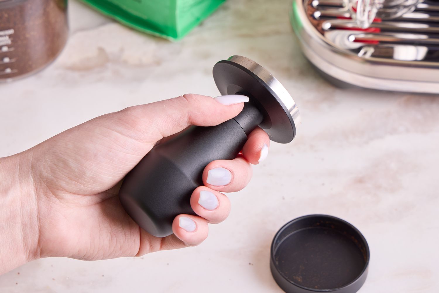 A person holding the Normcore tamper.