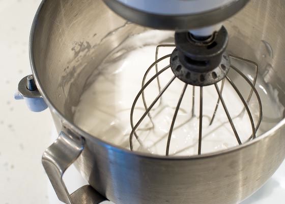 Egg whites being whipped until smooth and glossy. 