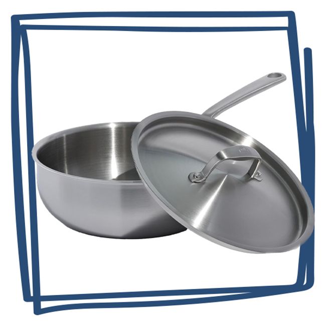 A stainless steel saucier with its lid slightly ajar featuring a single long handle