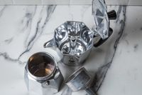 The disassembled parts of the Bialetti Moka Express moka pot.