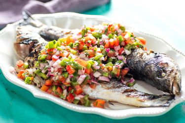 Platter of two whole grilled fish with Brazilian pico de gallo