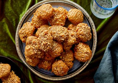A plate of cookies topped with crumbled nuts