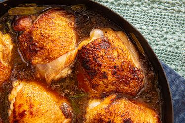 Cooked chicken thighs in a pan
