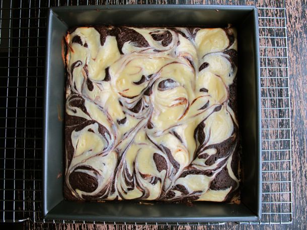 Overhead view of a pan of Cheesecake Swirl Brownies, fresh from the oven.