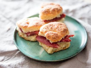 A plate of yeast-raised angel biscuits sandwiched with country ham