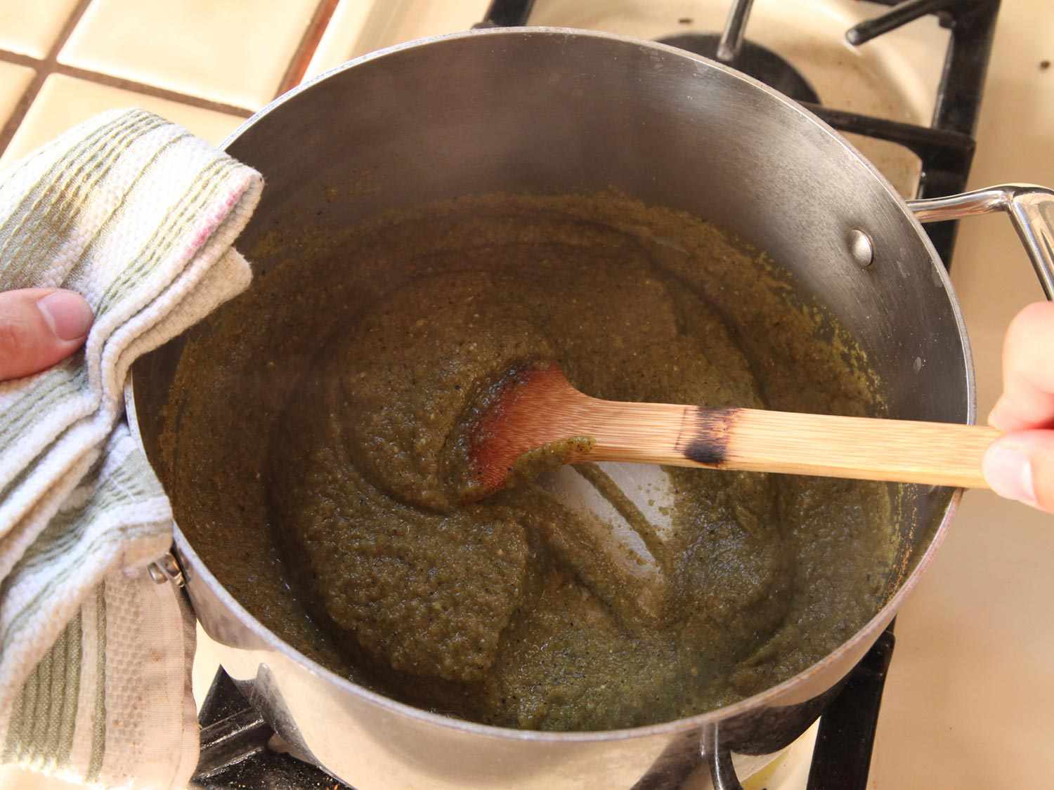 Cooking chile purée with spices in a stock pot. 