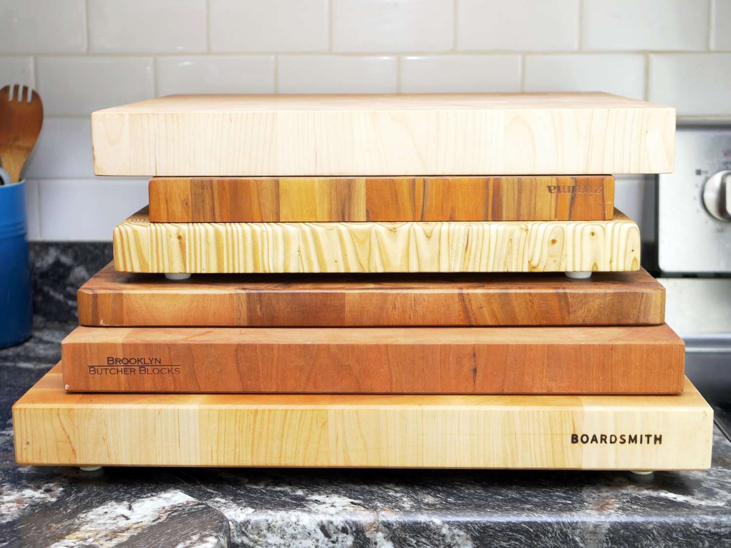 a variety of wooden cutting boards stacked on top of each other to show the different sizes