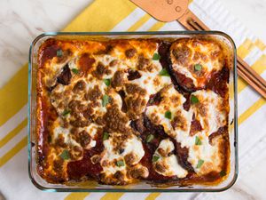 Baking dish of Italian-style eggplant parm with a golden topping of melted cheese