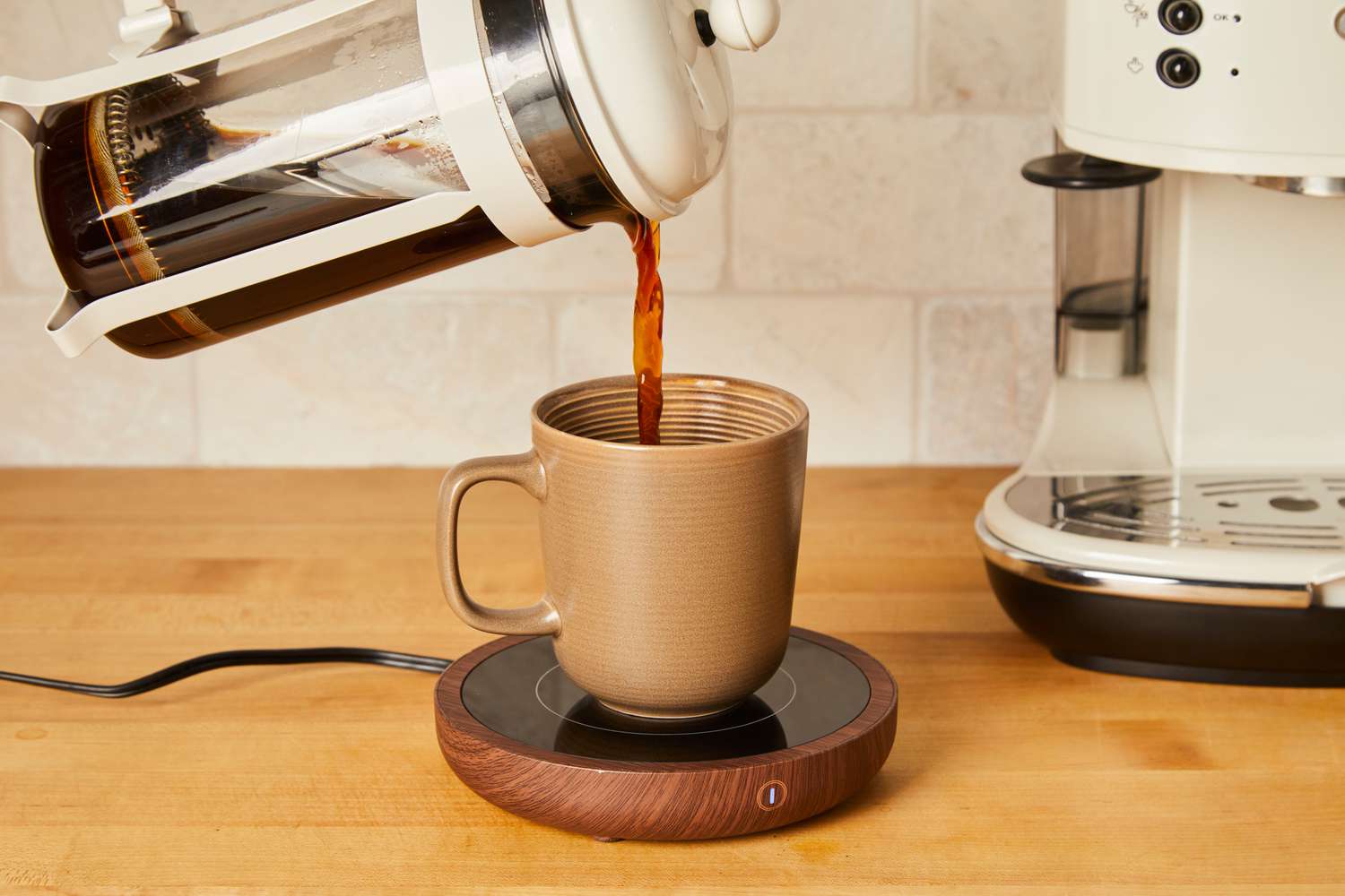 Person pouring coffee into Sweetful Coffee Mug Warmer