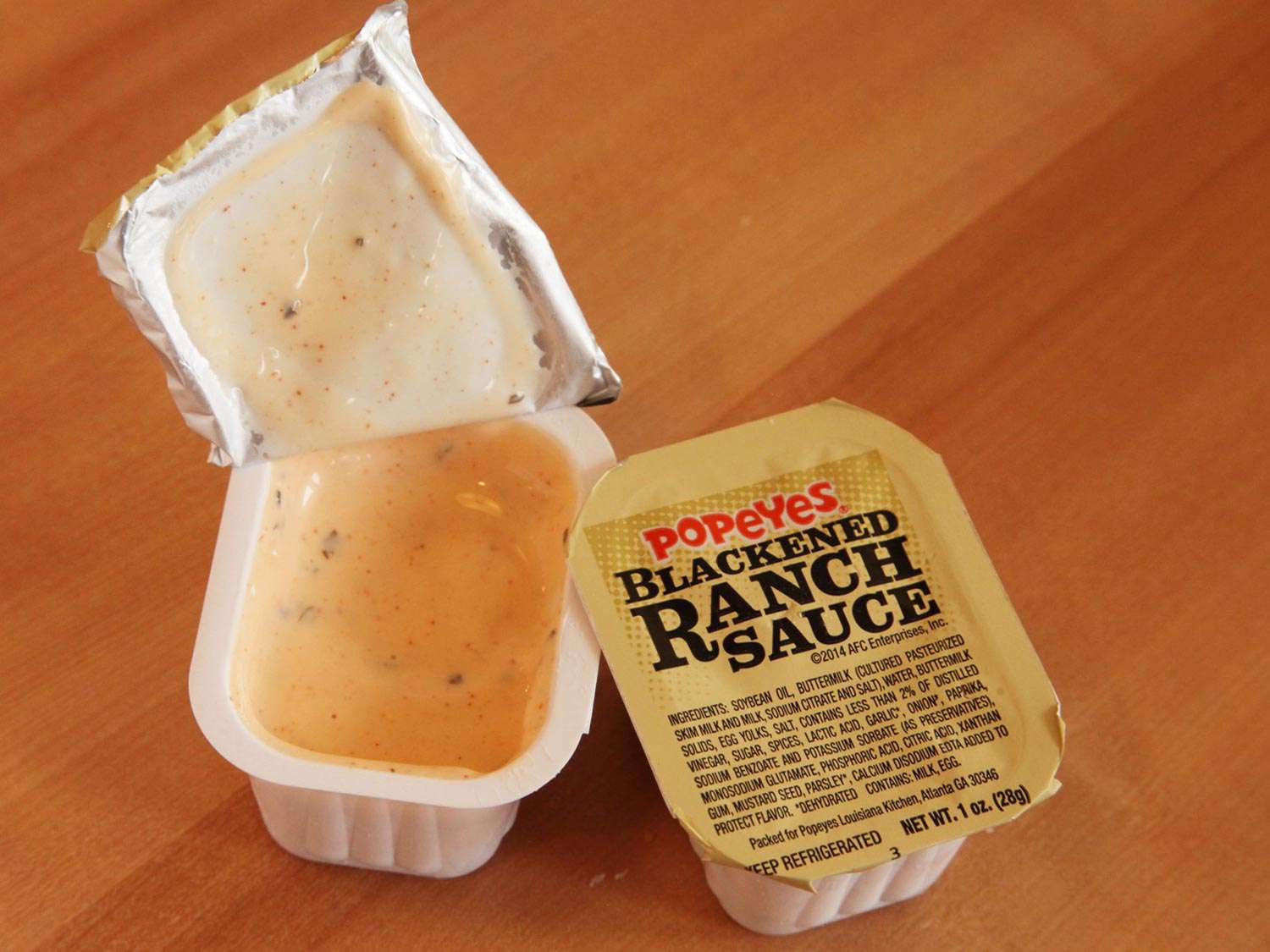 Two containers of blackened Ranch sauce from Popeye's
