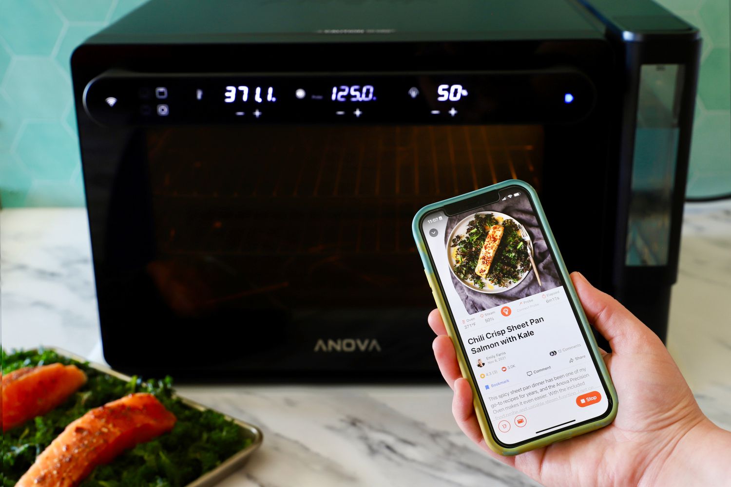 A hand holding a phone showing the Anova Precision Cooker app