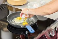 Eggs are cracked into the Misen Pre-Seasoned 10 Inch Carbon Steel Pan