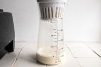 nut milk dripping into the carafe