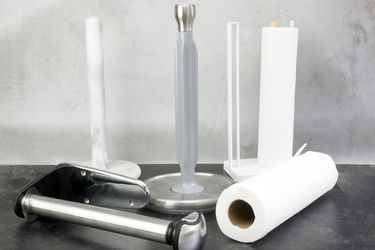 Paper towel holders on a gray and black backdrop