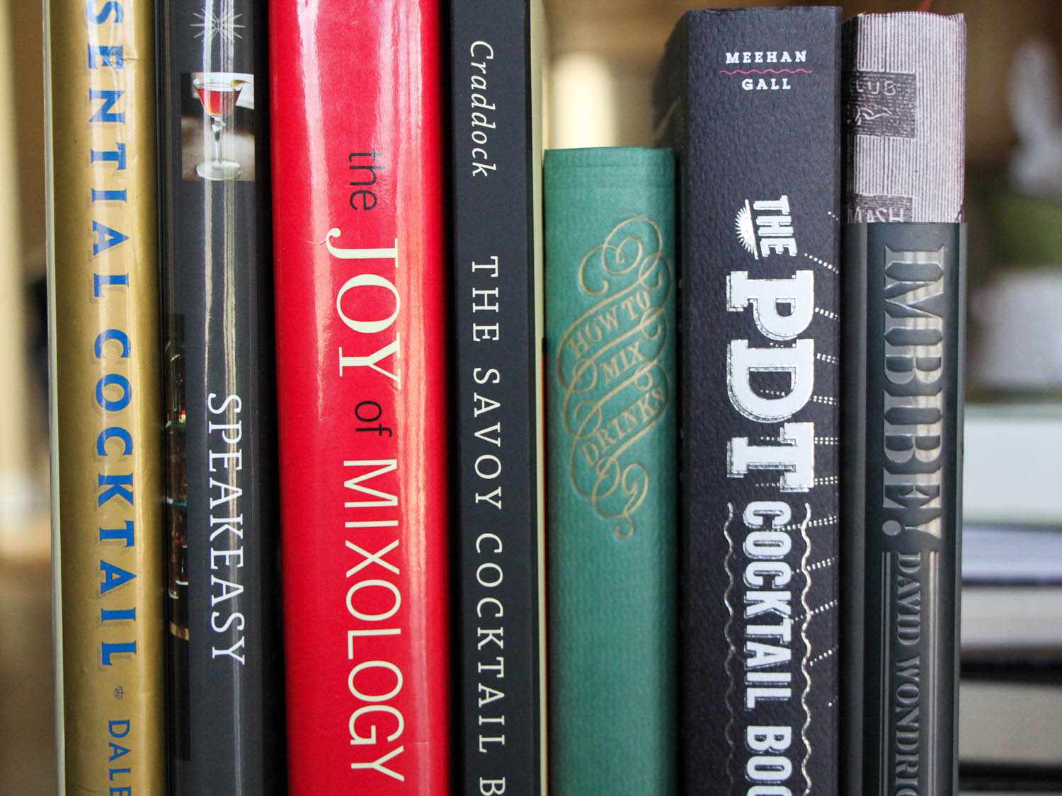 a closeup of the spines of cocktail books
