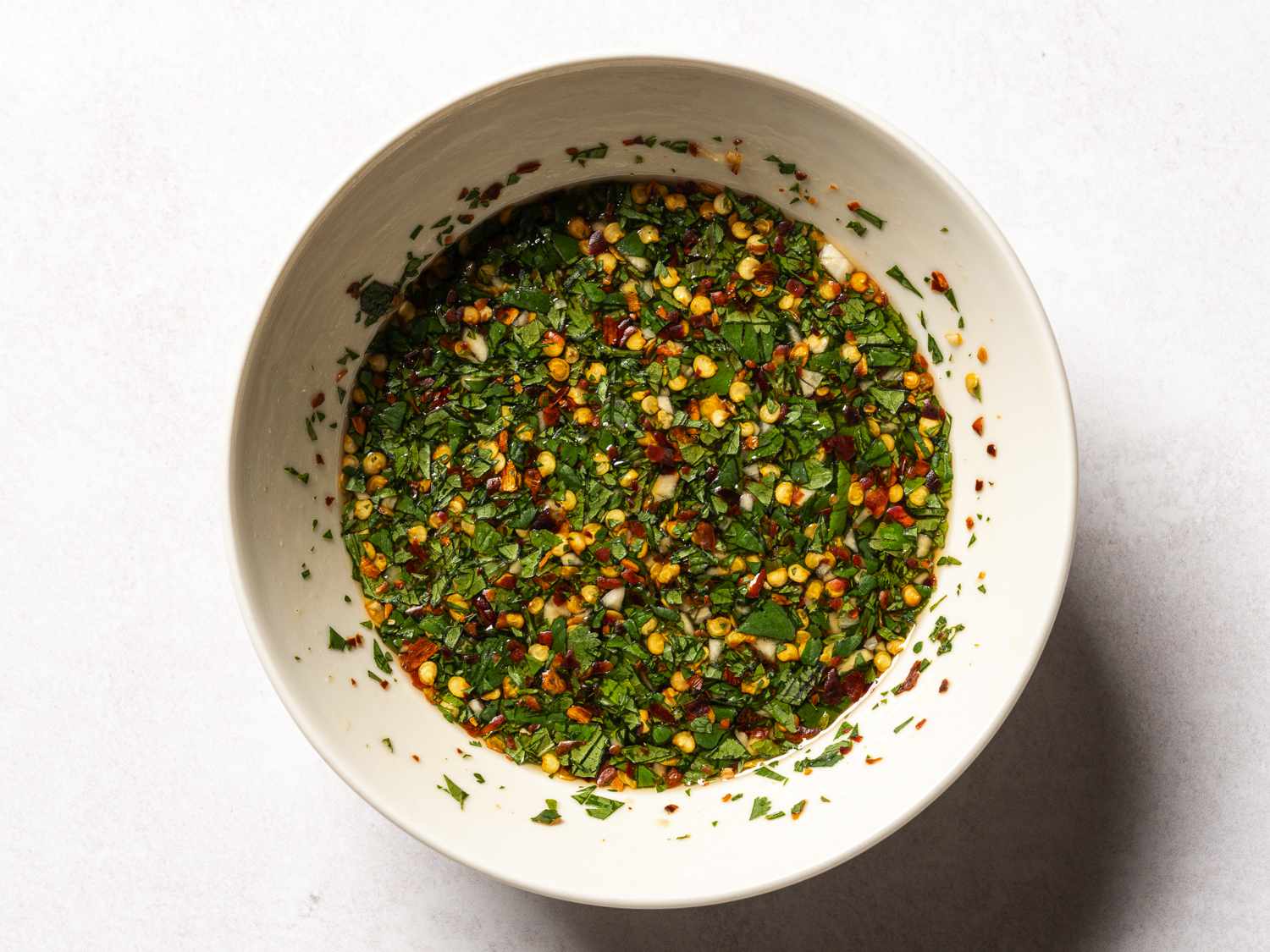A small white ceramic bowl holding the sauce.