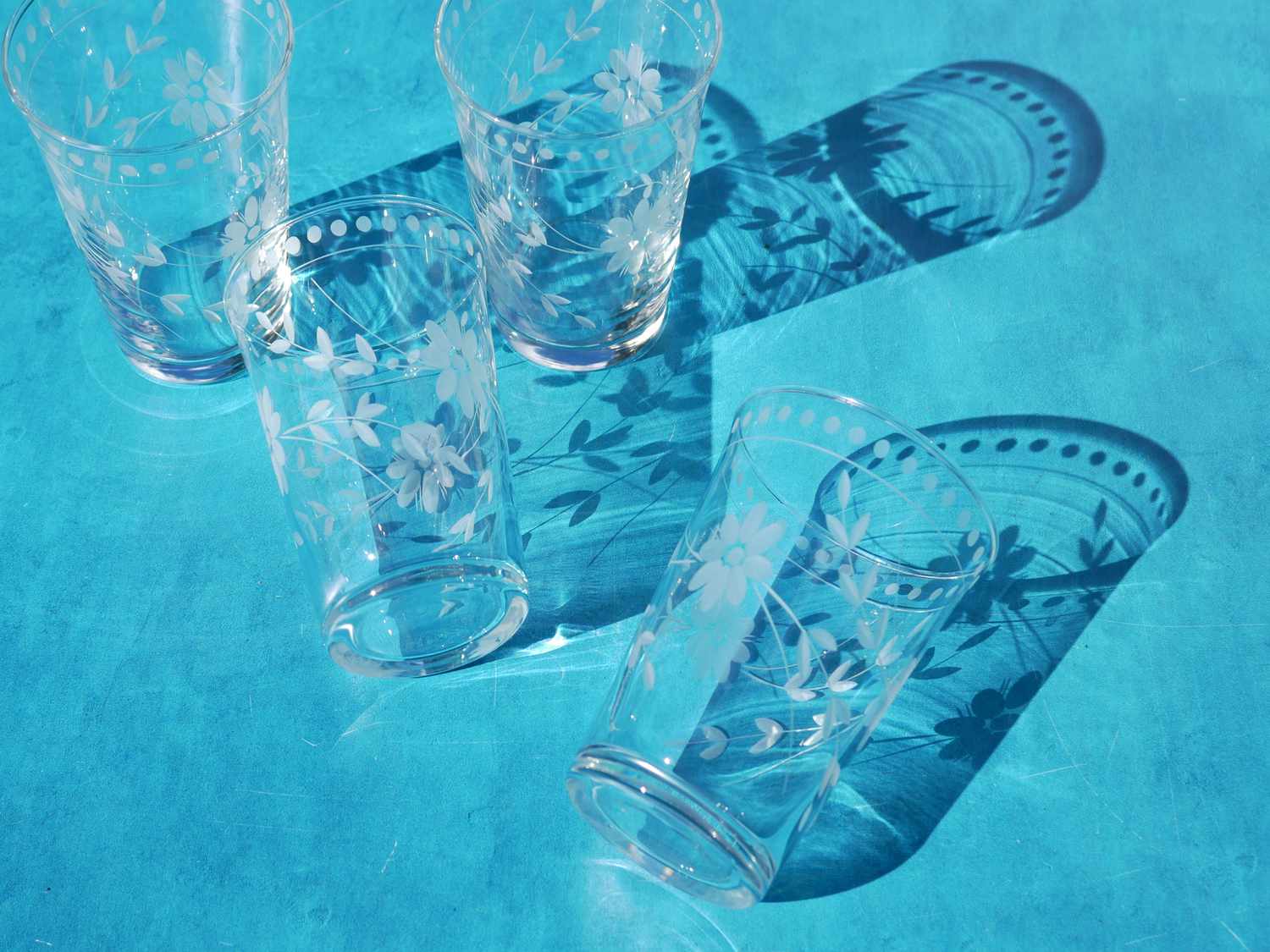 etched vintage glasses on a blue surface