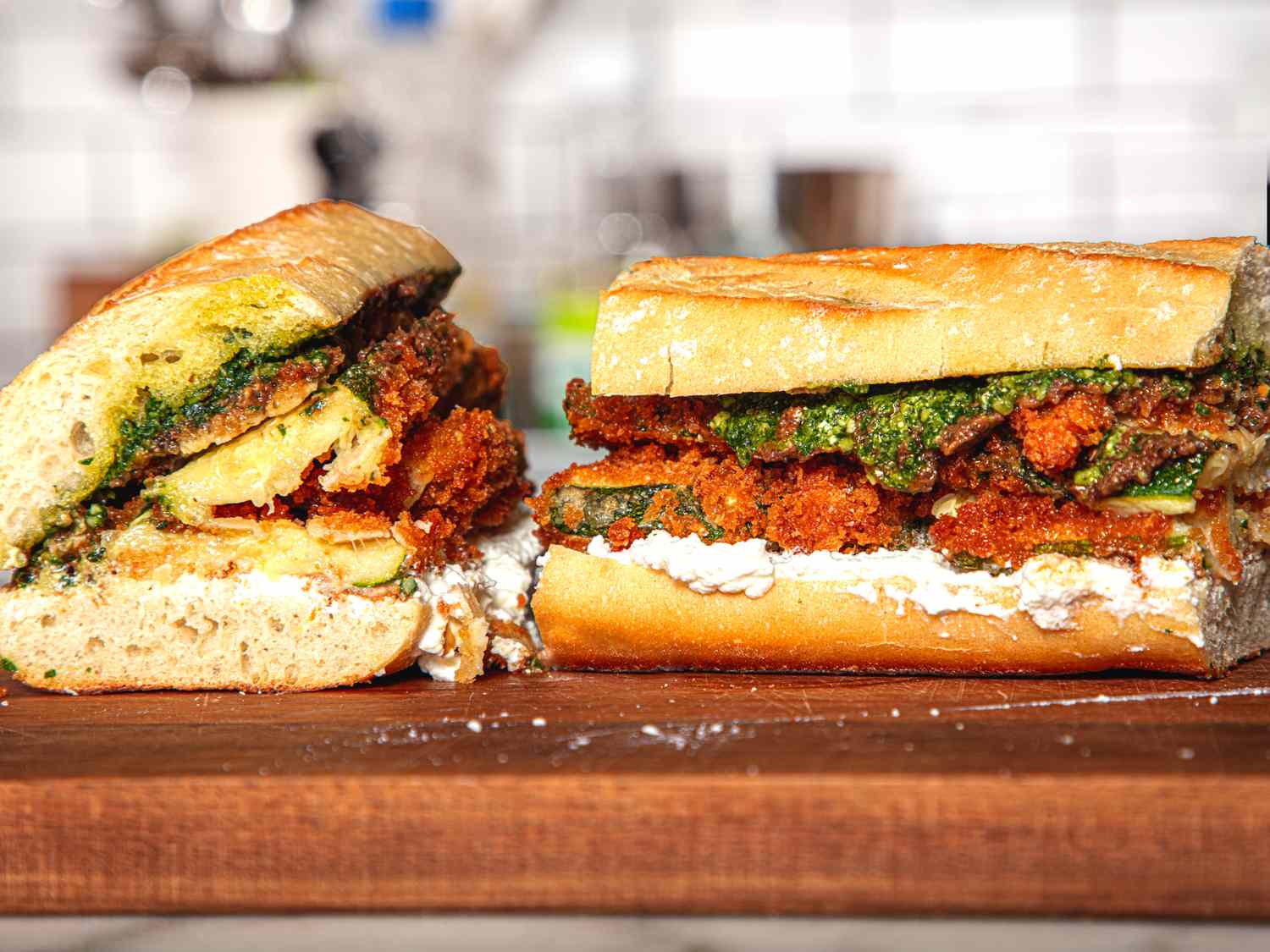 Crispy zucchini sandwich with pesto and cheese on a wooden surface