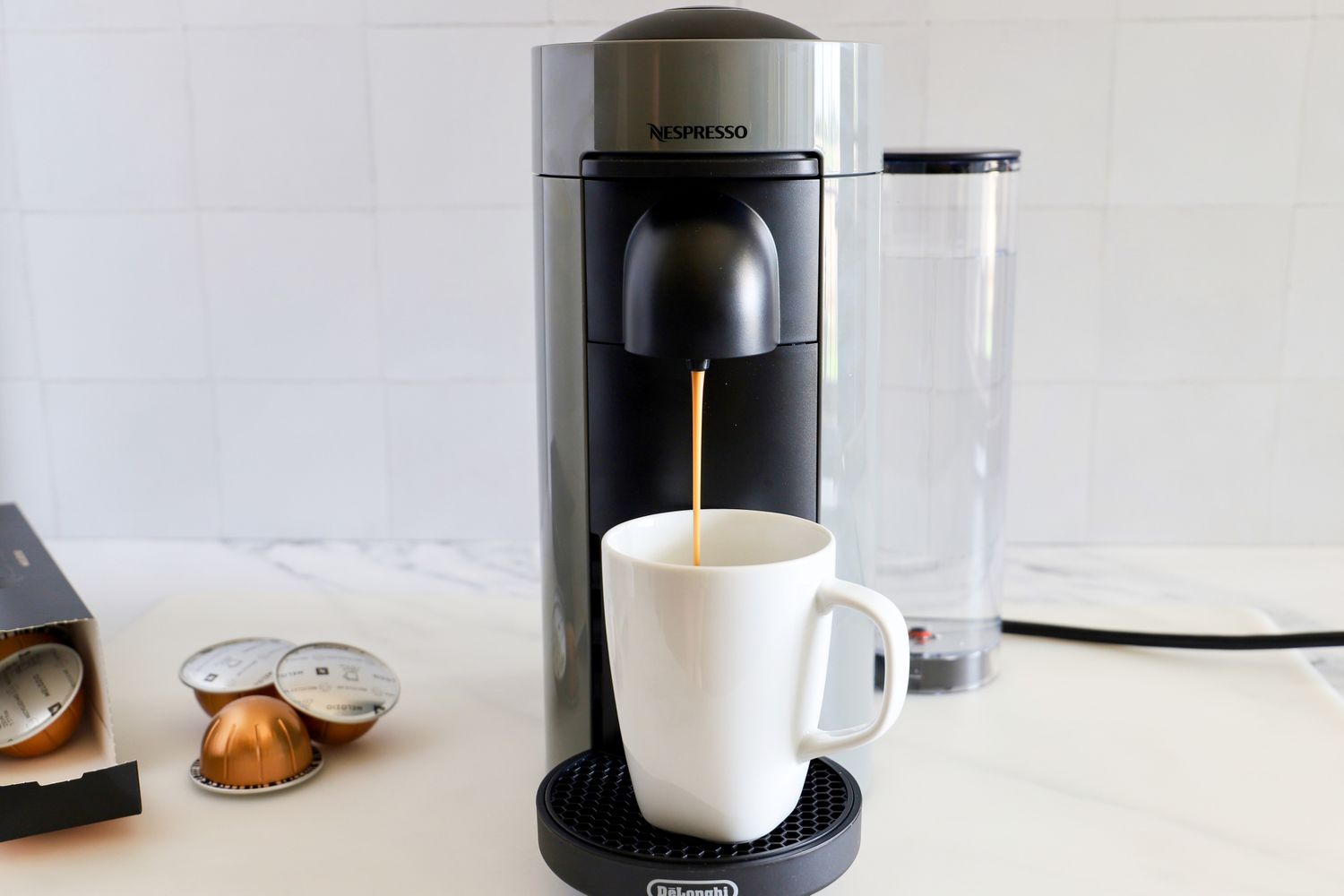 The Nespresso VertuoPlus Coffee and Espresso Machine by De'Longhi dispensing coffee into a mug