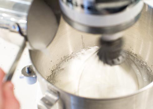 Sugar being slowly added into meringue. 