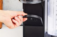 Hand holding the stand on the Ninja Thirsti Drink System