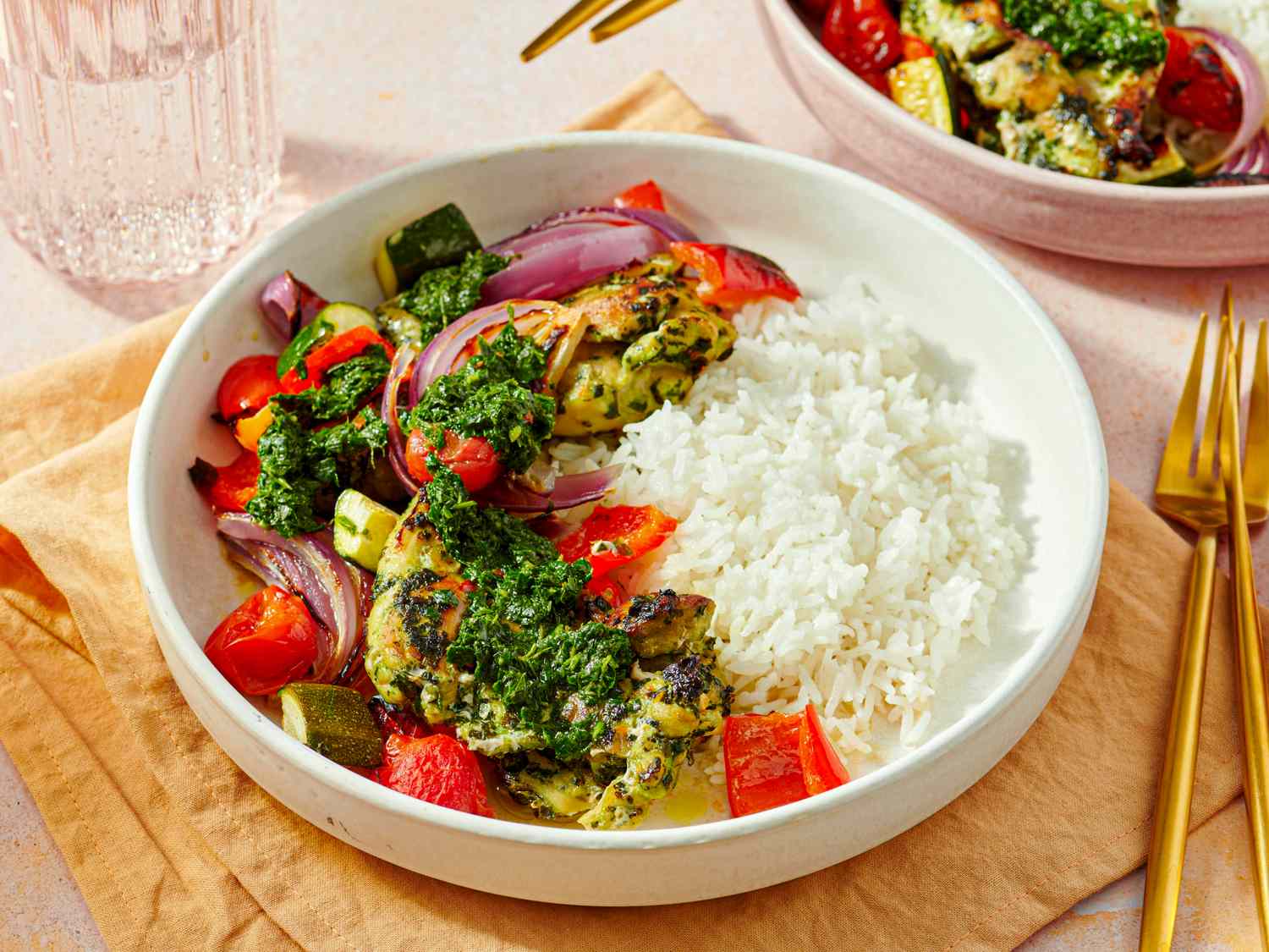Serving of chimichurri chicken thighs with vegetables and rice