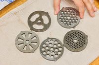 Different sizes of grinding plates of STX International Turboforce Classic 3000 Series Electric Meat Grinder & Sausage Stuffer