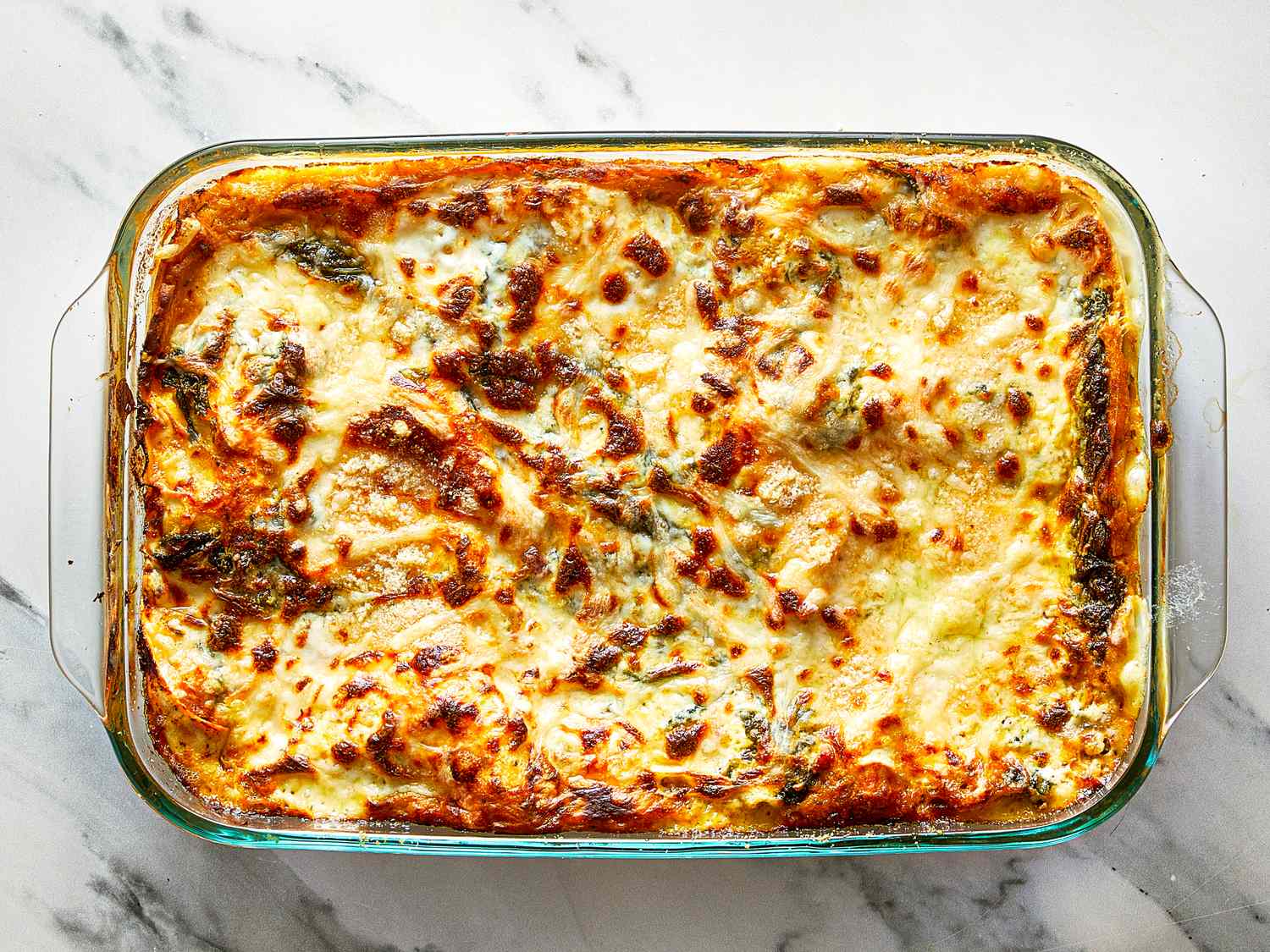 A baked lasagna in a glass baking dish