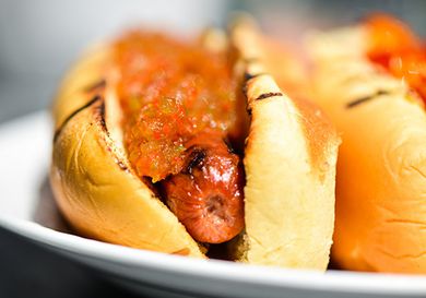 Closeup of a hot dog topped liberally with hot pepper relish.