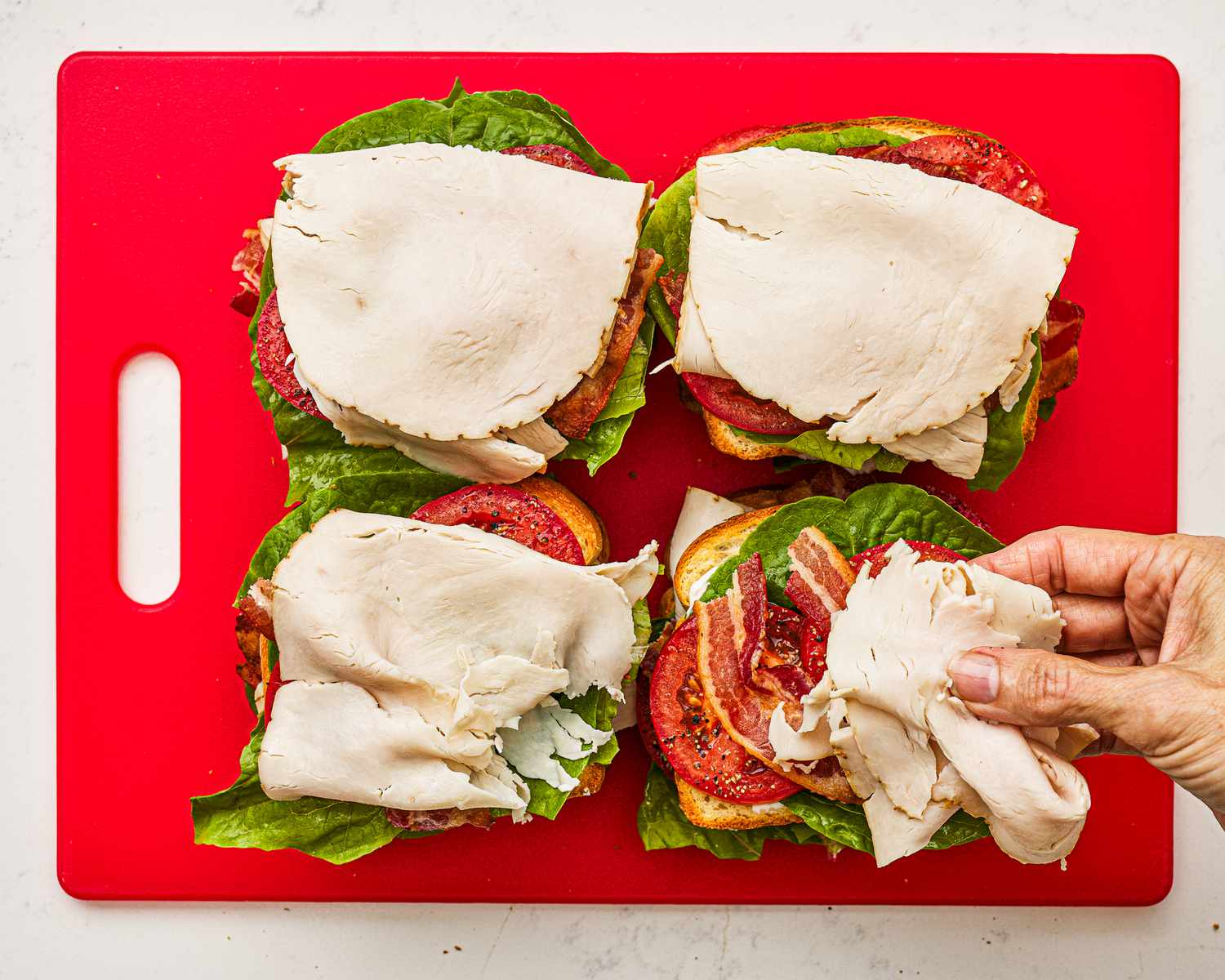 Placing turkey on second layer of sandwich