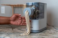 person making noodles with Philips Viva Collection Pasta and Noodle Maker 