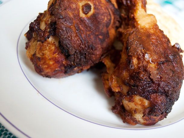 Closeup of green chile buttermilk fried chicken, served on a white plate.