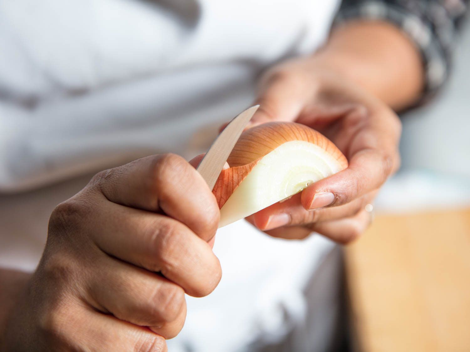 Author peels an onion with a tourné knife.