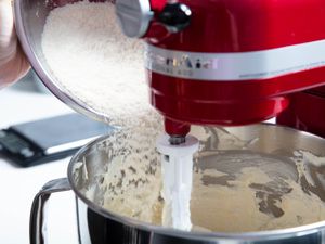 Pouring flour into stand mixer bowl