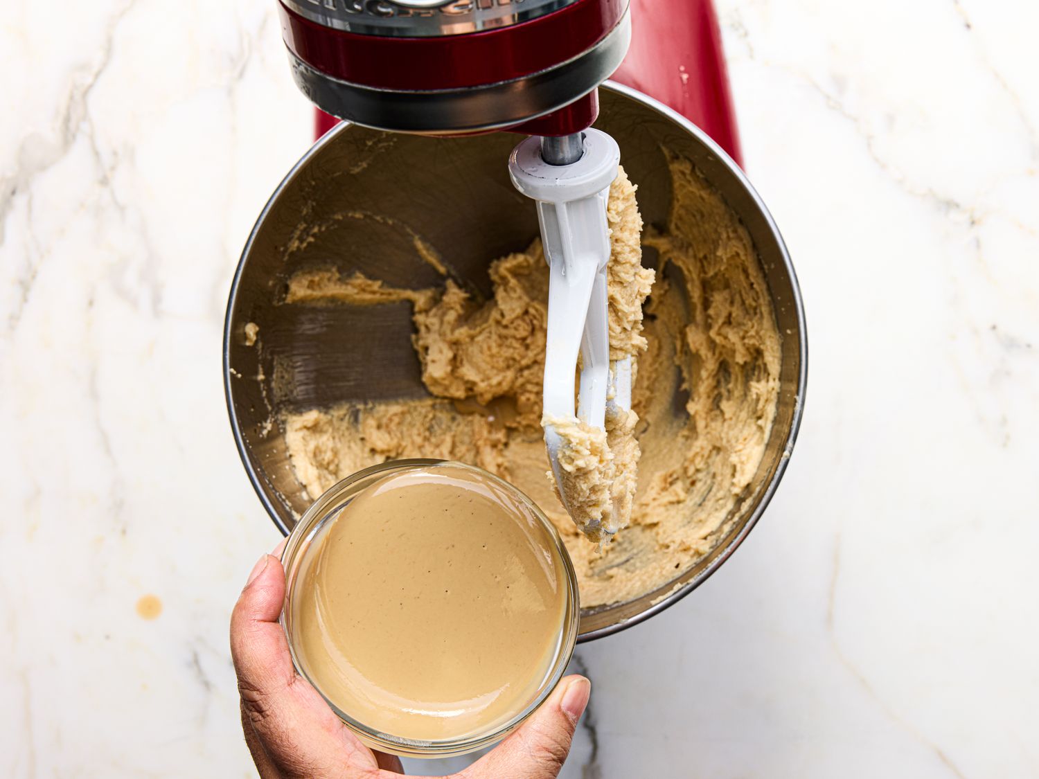 Mixing tahini into cookie dough in a stand mixer