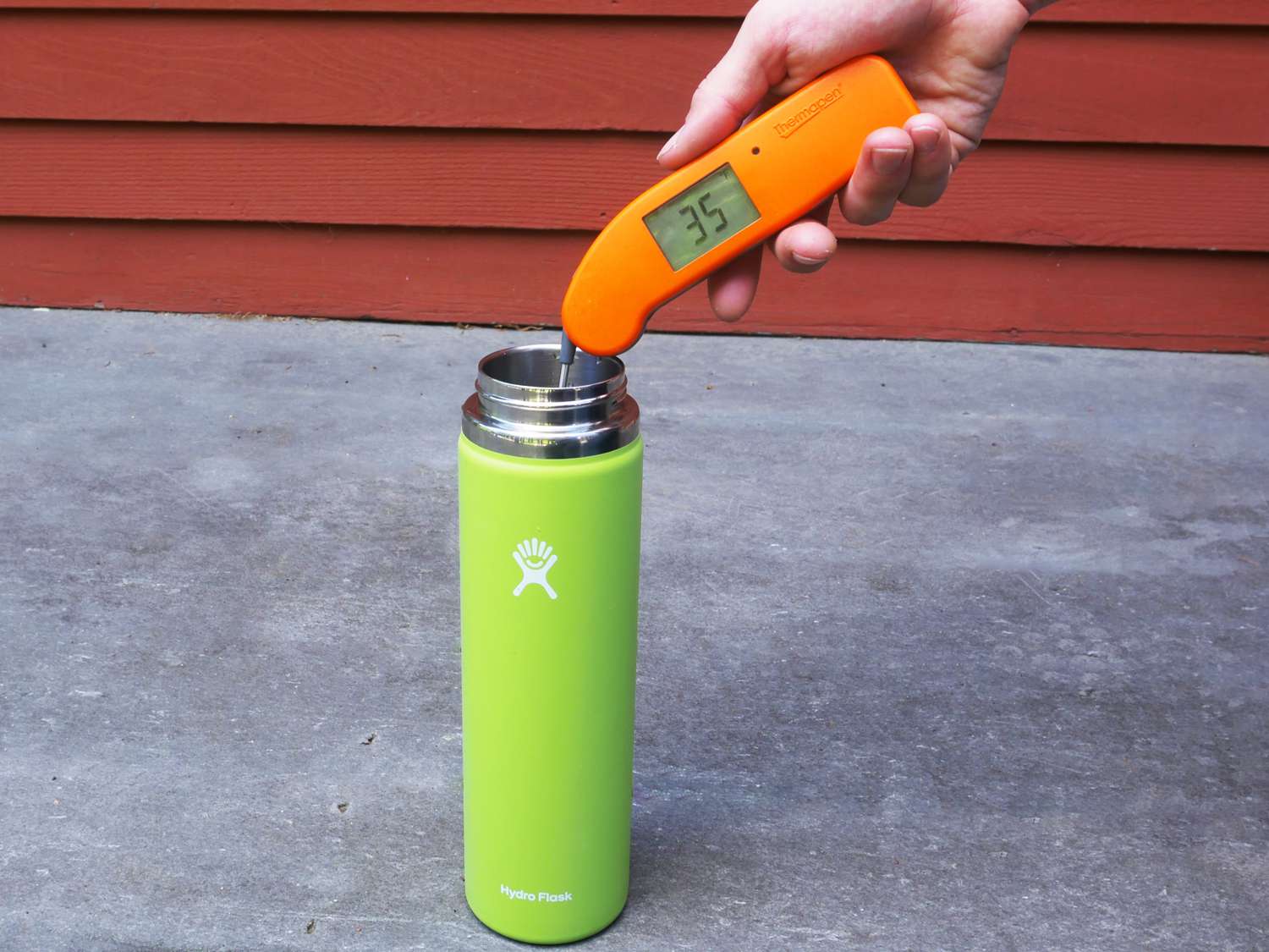 using a thermapen to take the temperature of a water bottle