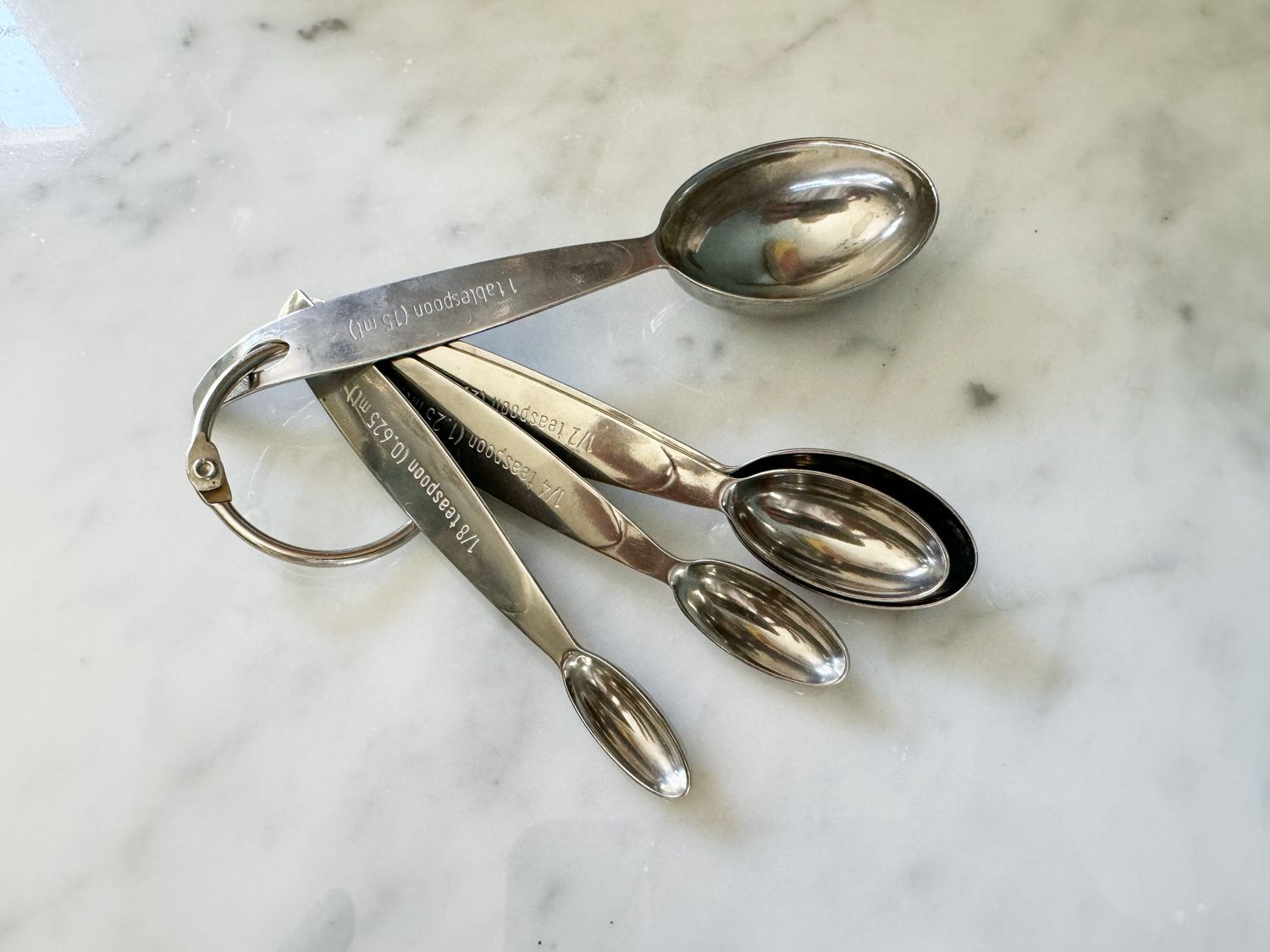 Cuisipro measuring spoons on a white countertop