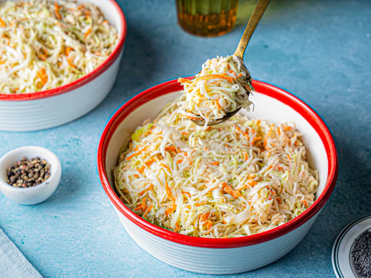 Bowl of coleslaw with a spoon lifting a portion