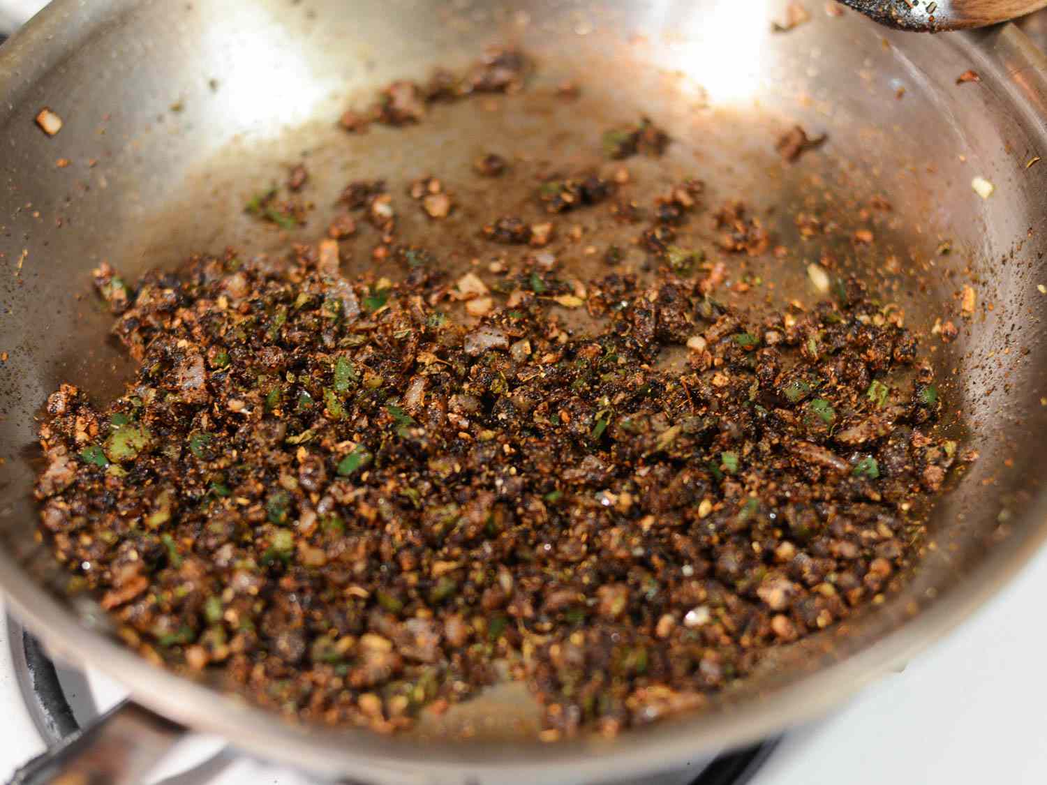 Finely diced onion and jalapeno sauteing with spices for tacos.