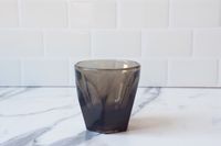 A grey Not Neutral espresso cup on a marble countertop.