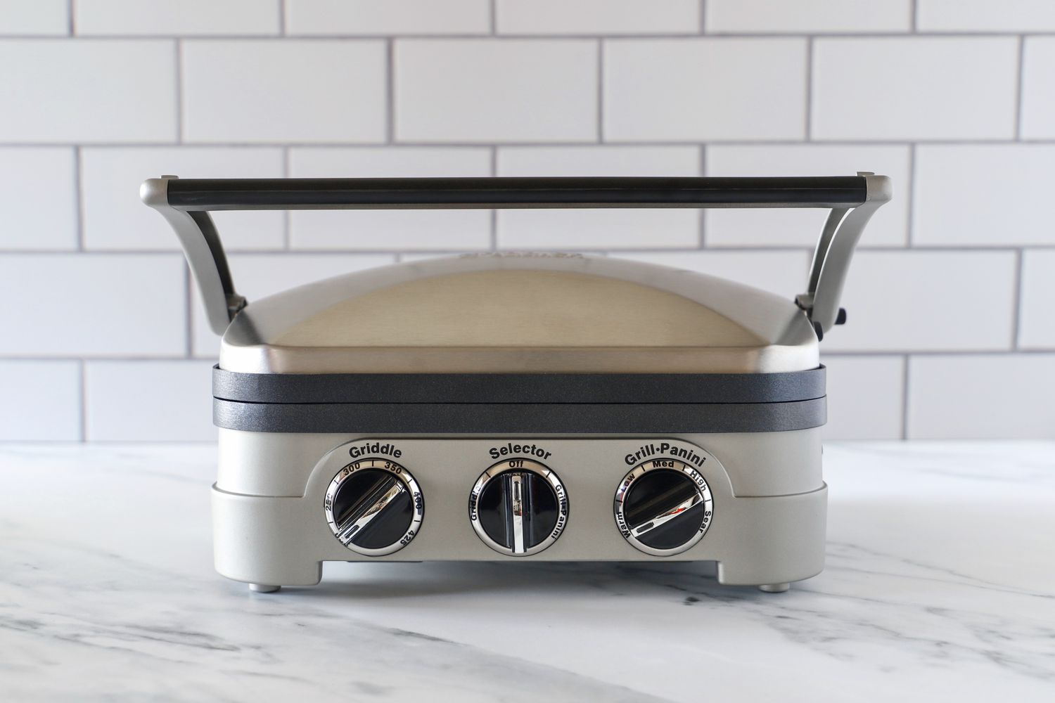 The Cuisinart Griddler panini press on a marble kitchen countertop.