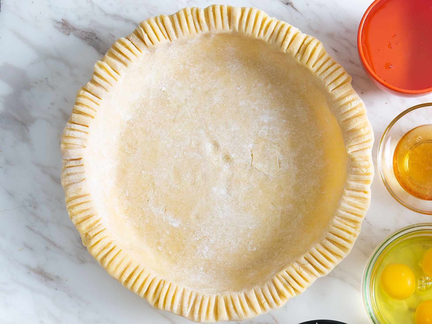 Top down view of a pie crust in a pie dish. 