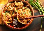 Bowl of Sichuan-style wontons in hot and sour vinegar and chili oil sauce 