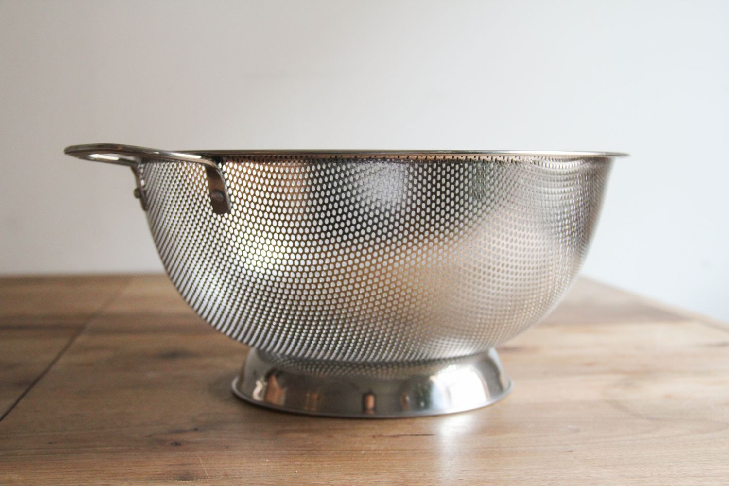 A mesh colander on a table