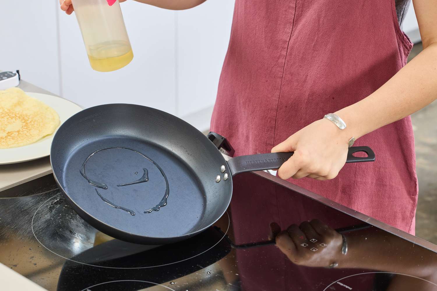 Oil is poured into the Merten & Storck Pre-Seasoned 10-inch Carbon Steel Frying Pan