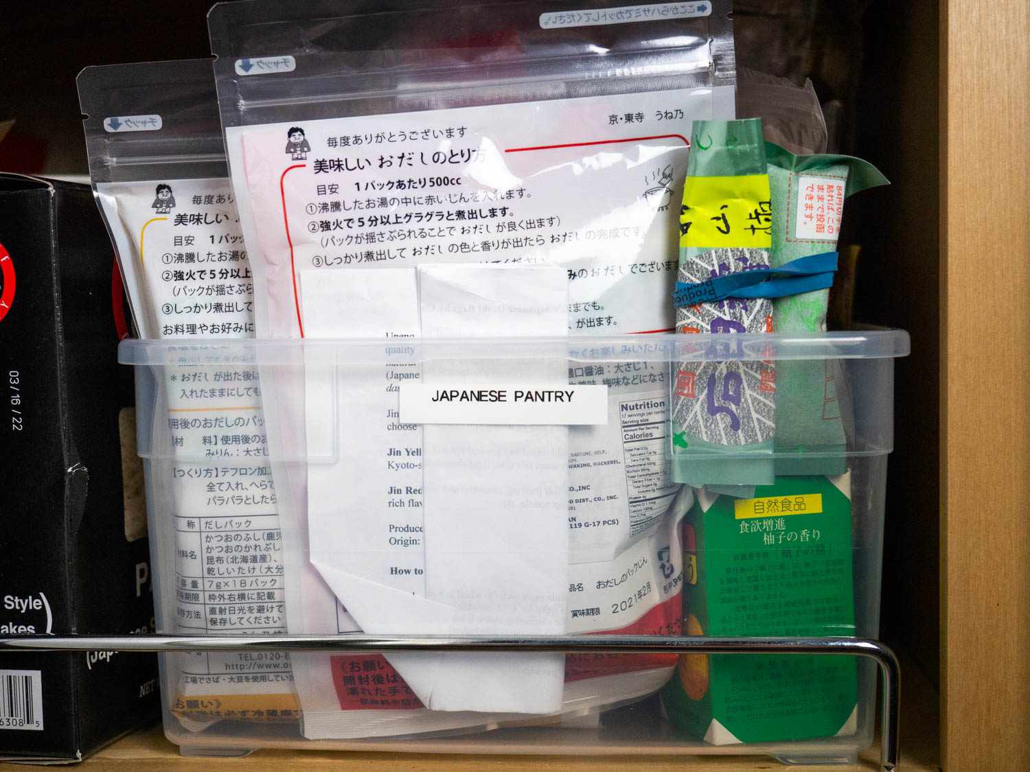 Plastic box filled with containers of non-perishable Japanese pantry ingredients
