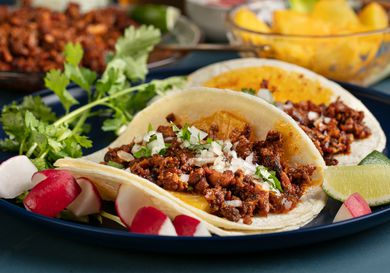 Plated tacos al pastor from the side